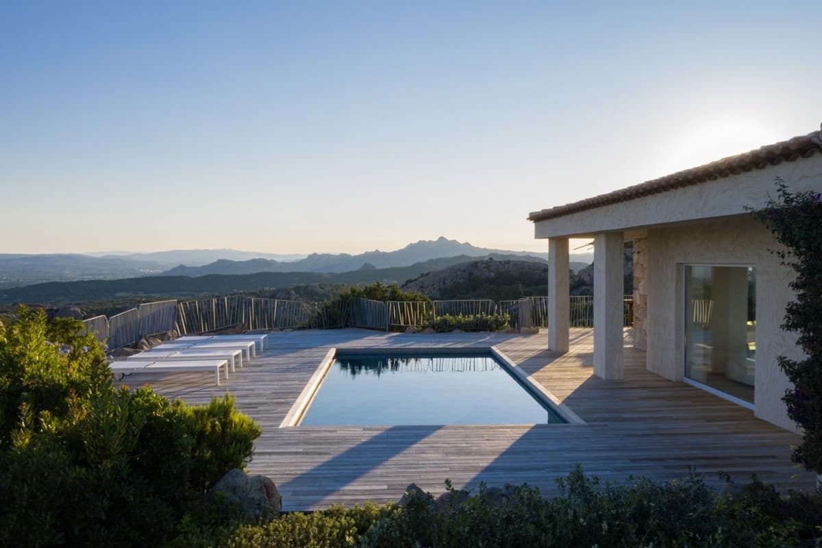 Villa Horizon's pool at dusk with silhouetted mountains in the distance
