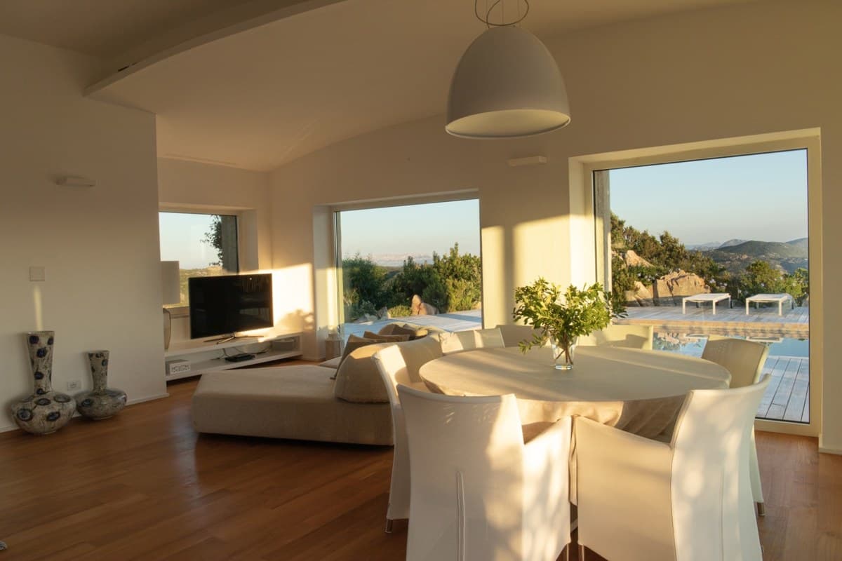 Dining area at Villa Horizon with pool and mountain views through the windows